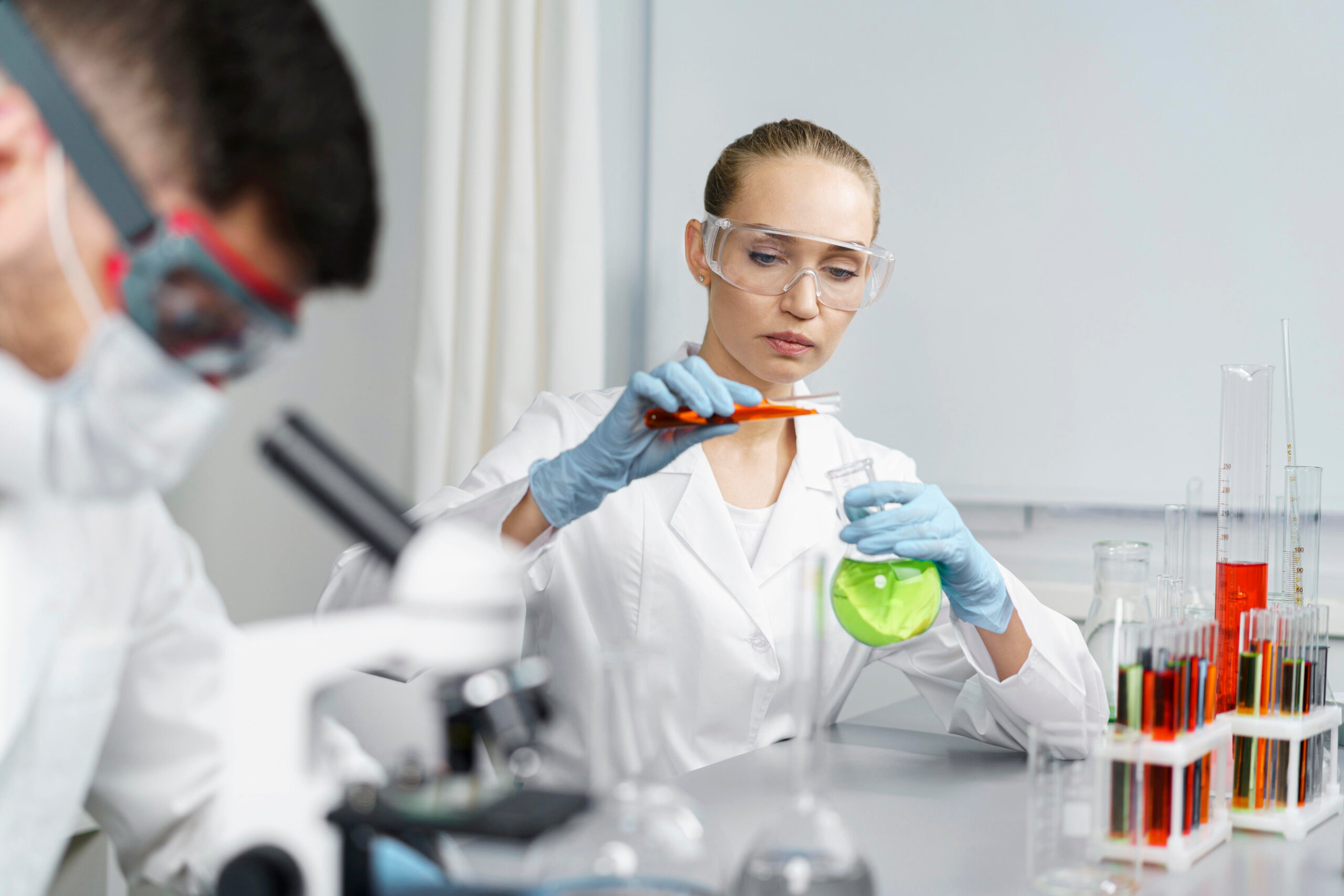 Upperton scientist examining a formulation flask